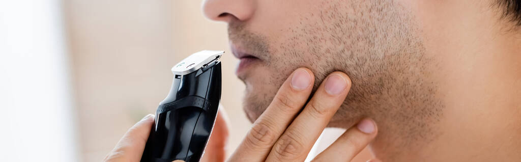 cropped view of man shaving with electric razor, banner - Photo, Image