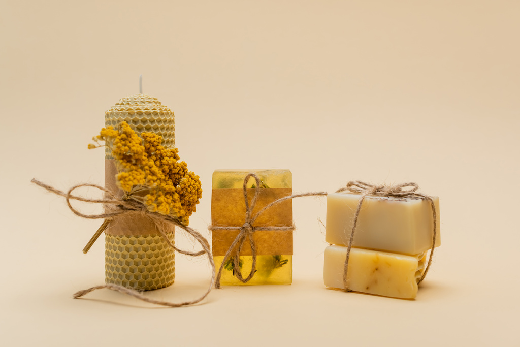 Handmade candle and soap bars with twine on beige background  - Photo, Image