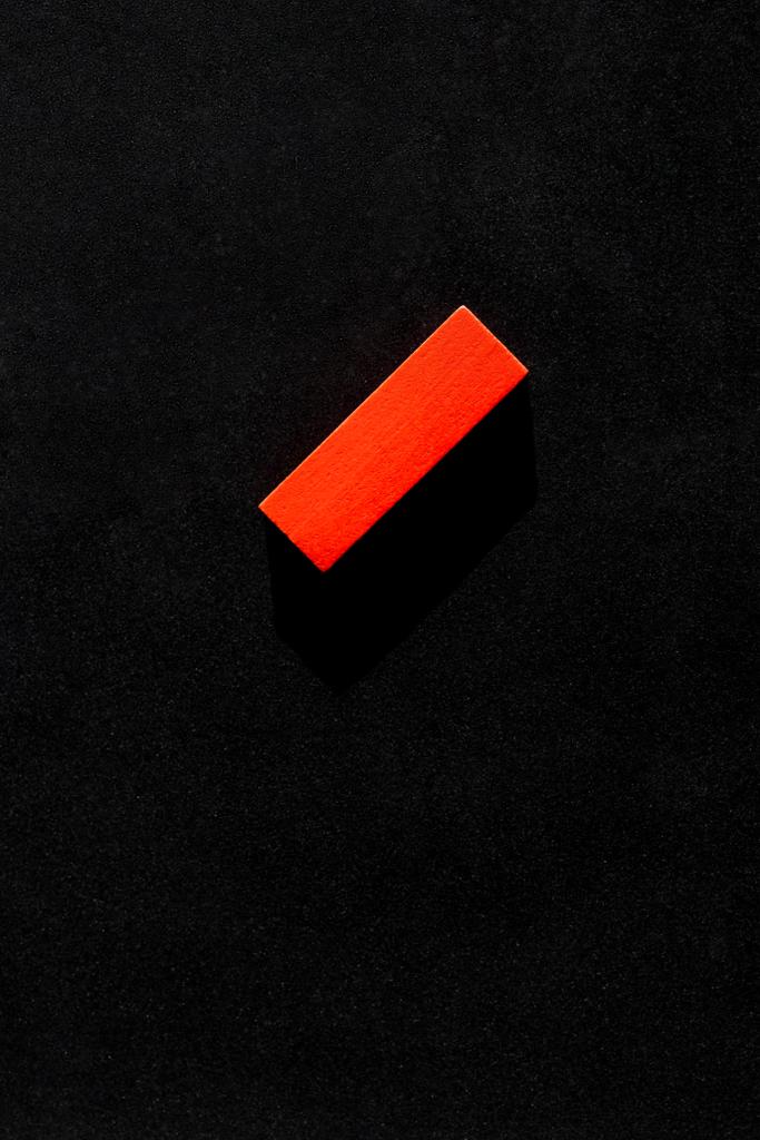 top view of bright red block on black background with copy space - Photo, Image