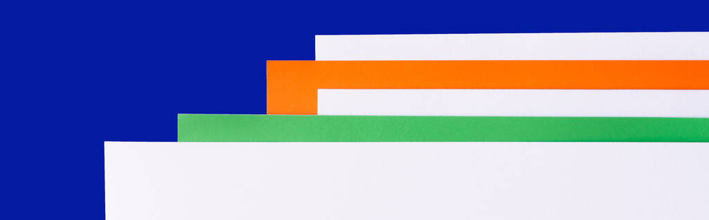 wielobarwne arkusze papieru na niebieskim tle, baner - Zdjęcie, obraz