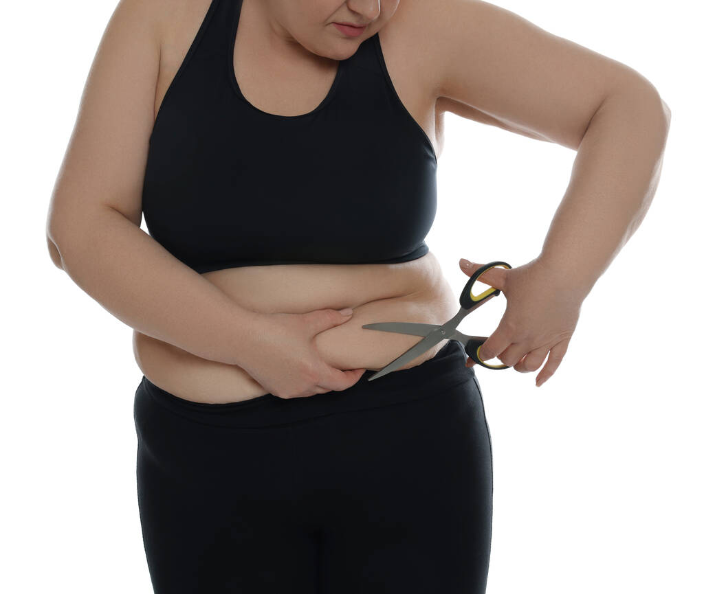 Obese vrouw met schaar op witte achtergrond, close-up. Gewichtsverlies operatie - Foto, afbeelding