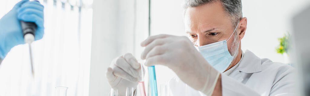 biotechnologist in medical mask and latex gloves working with test tubes in lab, banner - Photo, Image