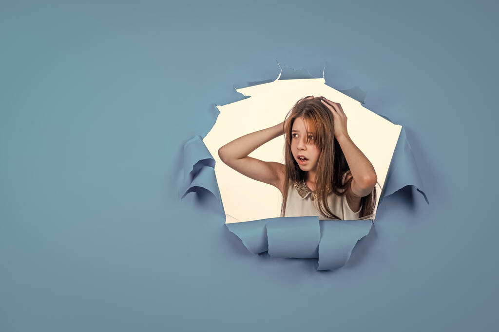 worried teen girl on blue background, copy space, problem - Photo, Image