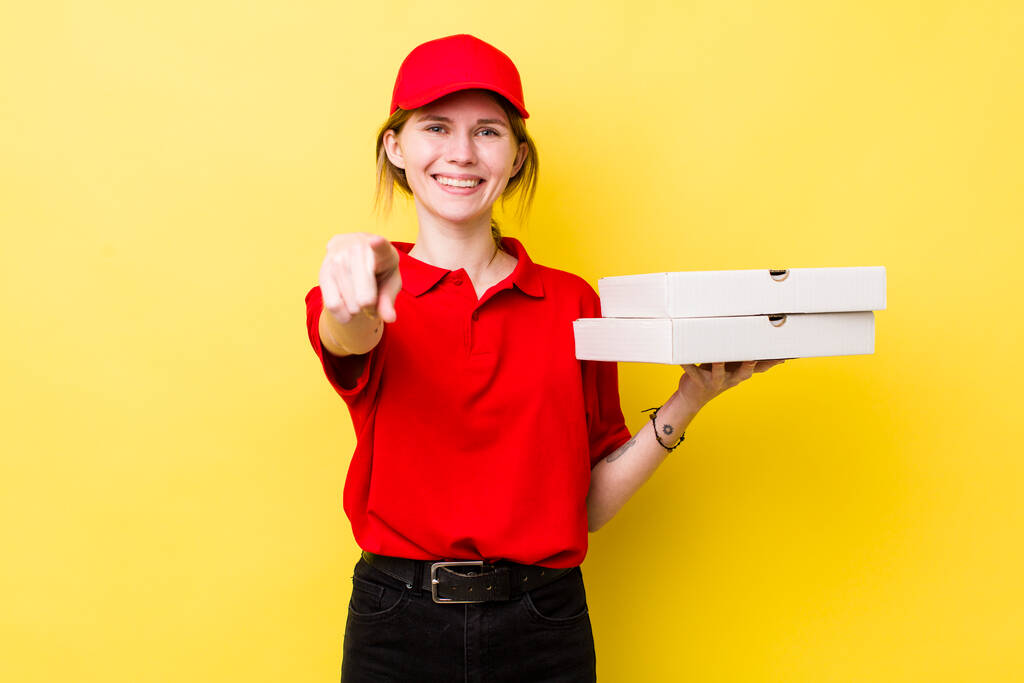 red head pretty woman pointing at camera choosing you. delivery pizza concept - 写真・画像