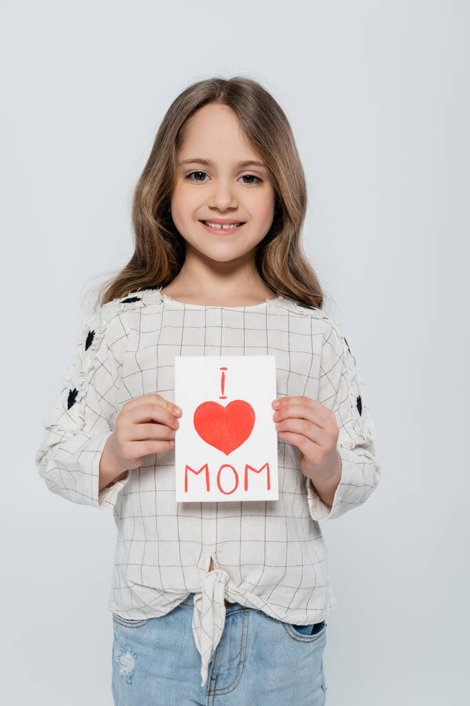 front view of joyful girl with mothers day greeting card isolated on grey - Photo, Image