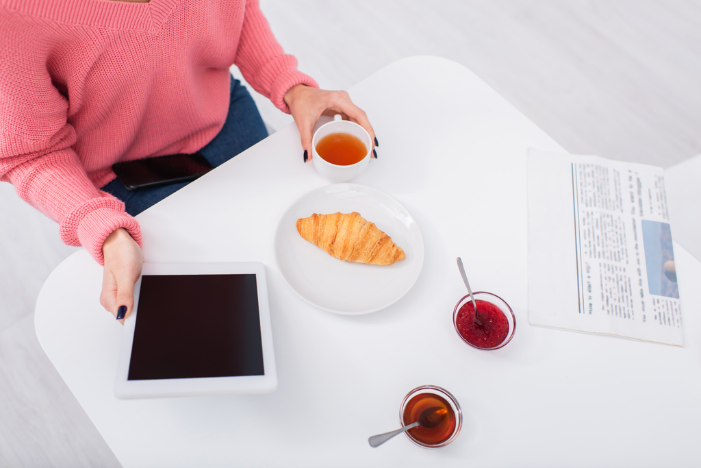 обрізаний вид жінки, використовуючи цифровий планшет під час сніданку
  - Фото, зображення