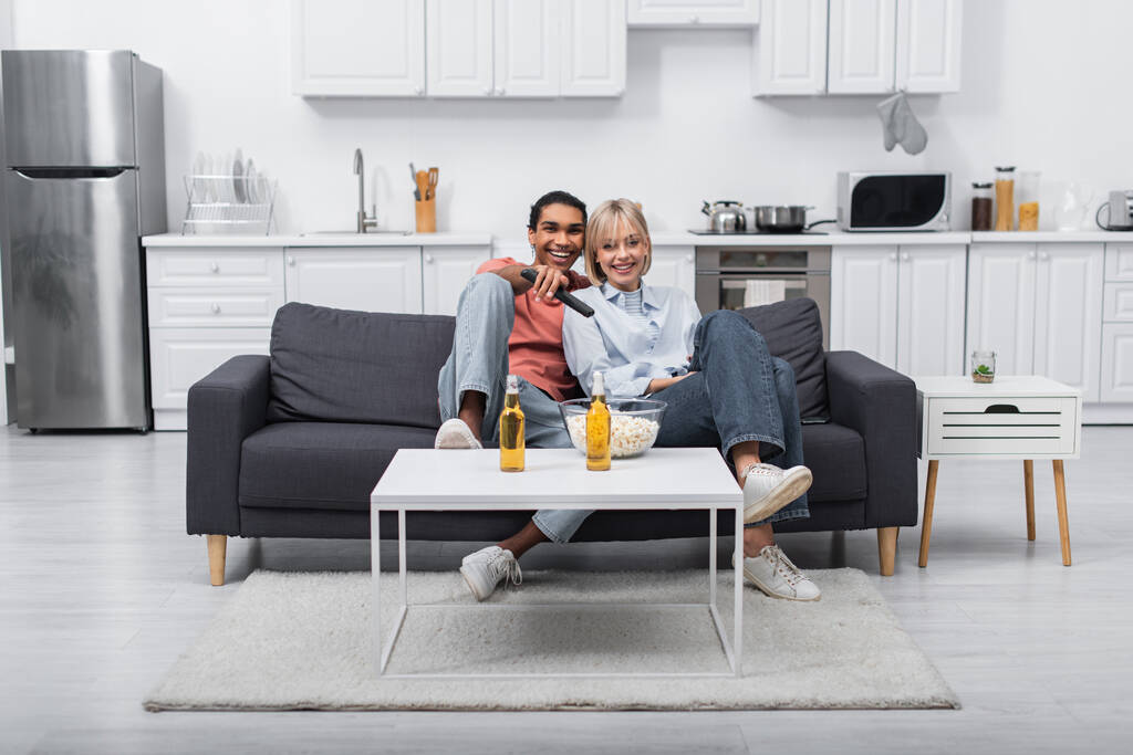 happy interracial couple watching movie together  - Φωτογραφία, εικόνα