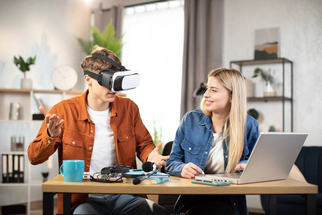 Excited young people using VR glasses for having fun at home - Foto, imagen