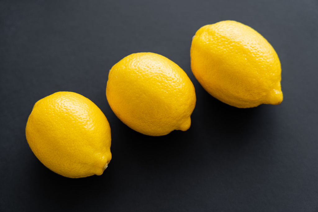 Top view of ripe lemons on black background  - Photo, image