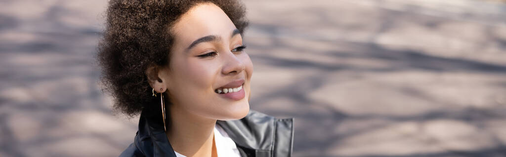 sunshine on face of positive african american woman in jacket, banner - Foto, Imagem