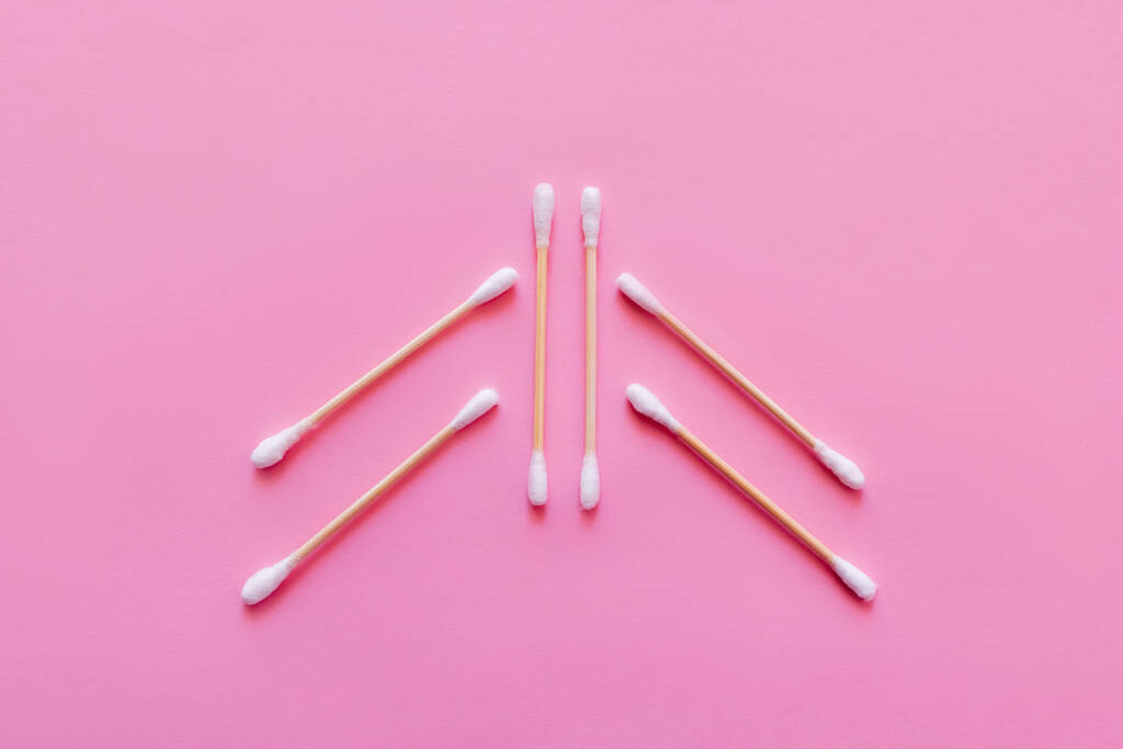 top view of six ear sticks on pink background - Fotoğraf, Görsel