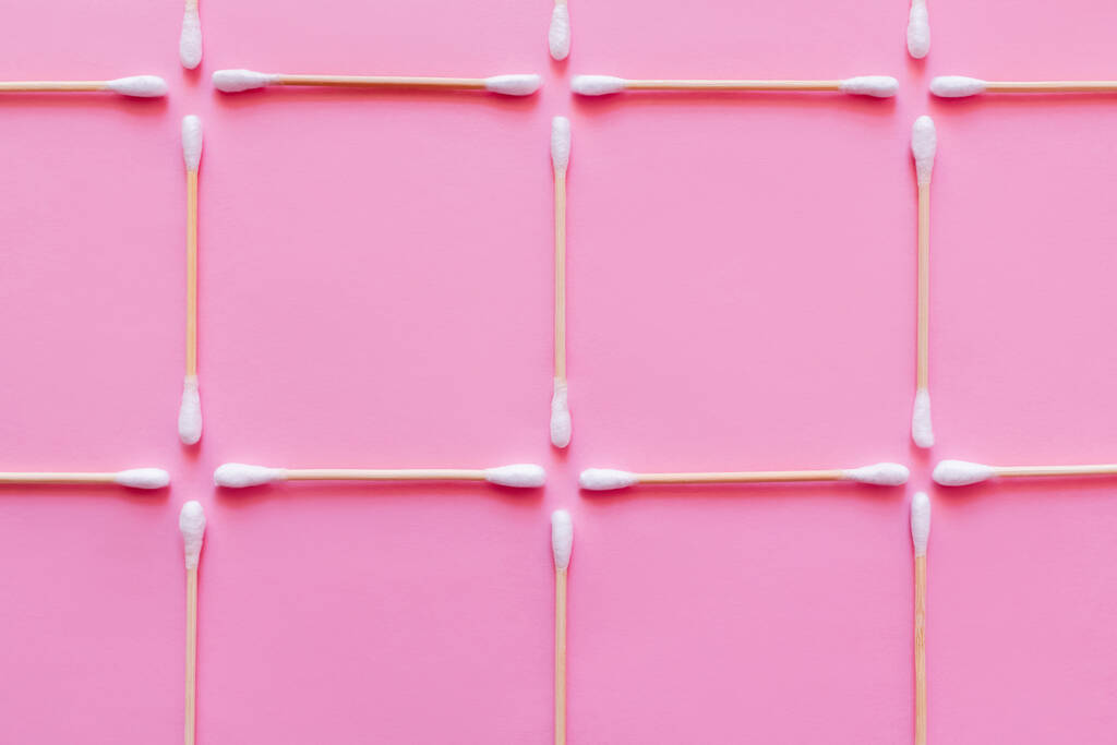 Ansicht von Quadraten aus Wattestäbchen auf rosa Hintergrund - Foto, Bild