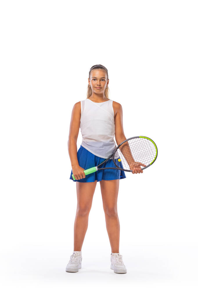 Tennis player on the blue background. Beautiful girl teenager and athlete with racket in white sporswear and hat on tennis court. Fashion and sport concept. - Fotó, kép