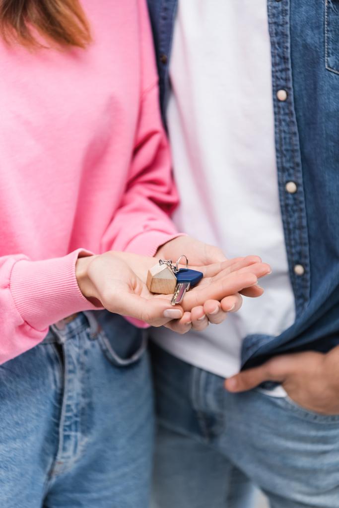 Cropped view of woman holding key near blurred boyfriend  - Photo, image