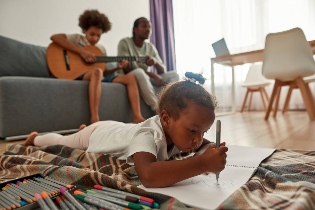 Black girl draw and father with son play on guitar - Photo, Image