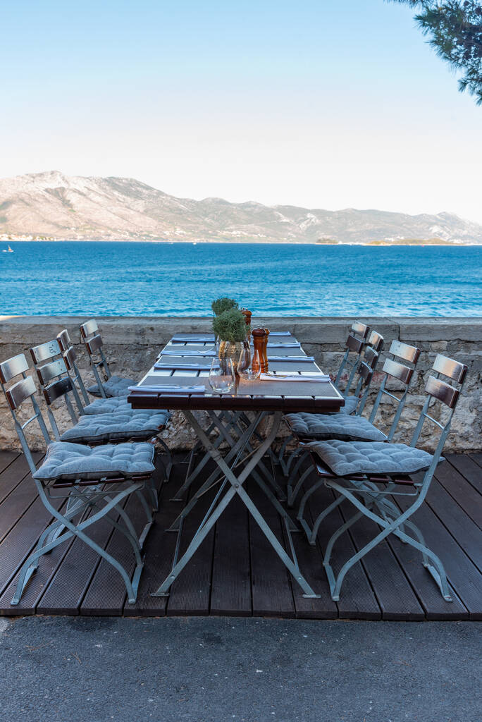 Chairs and tables at seaside promenade in the old town of Korcula, Croatia - Photo, Image