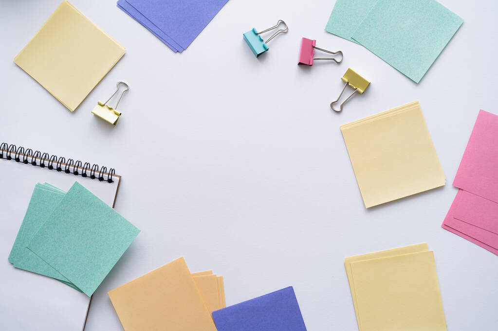 flat lay of colorful paper notes and fold back clips on white - Fotografie, Obrázek