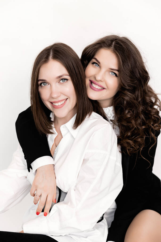 Close up portrait of beautiful business women in stylish suits posing in studio on white background.  - 写真・画像
