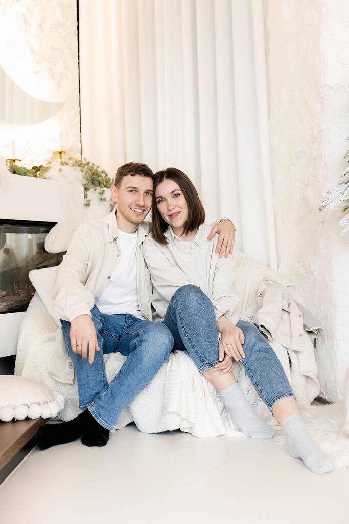 portrait of beautiful couple with Christmas decorations at home - Фото, изображение
