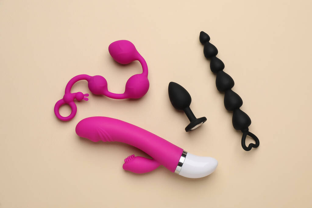 Sex toys on beige background, flat lay - Фото, изображение