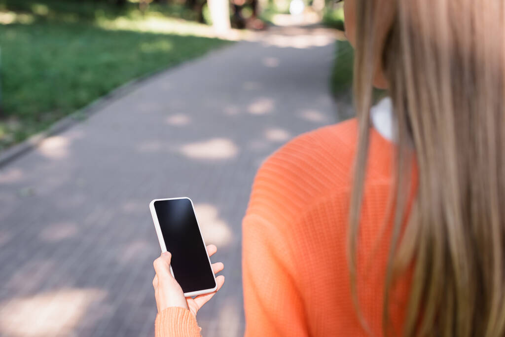 vista recortada de la mujer sosteniendo teléfono inteligente con pantalla en blanco
 - Foto, Imagen