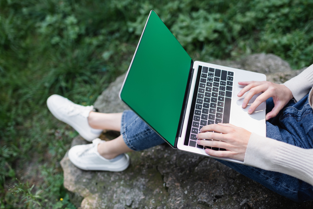high angle view of woman using laptop with green screen - 写真・画像