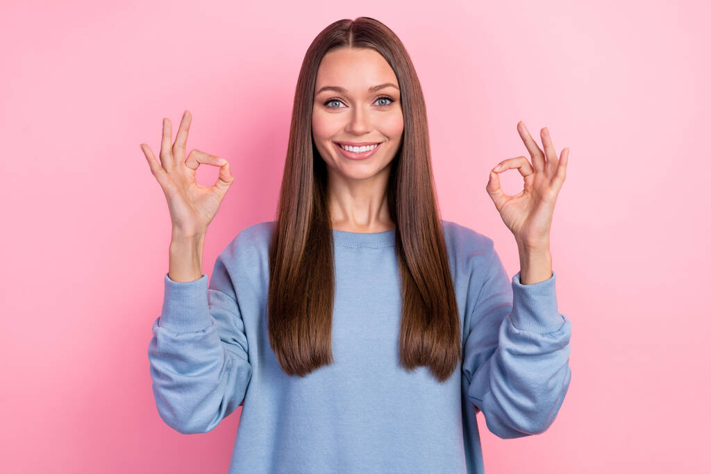 Portrait of attractive cheerful girl showing ok-sign ad solution isolated over pink pastel color background - Photo, Image