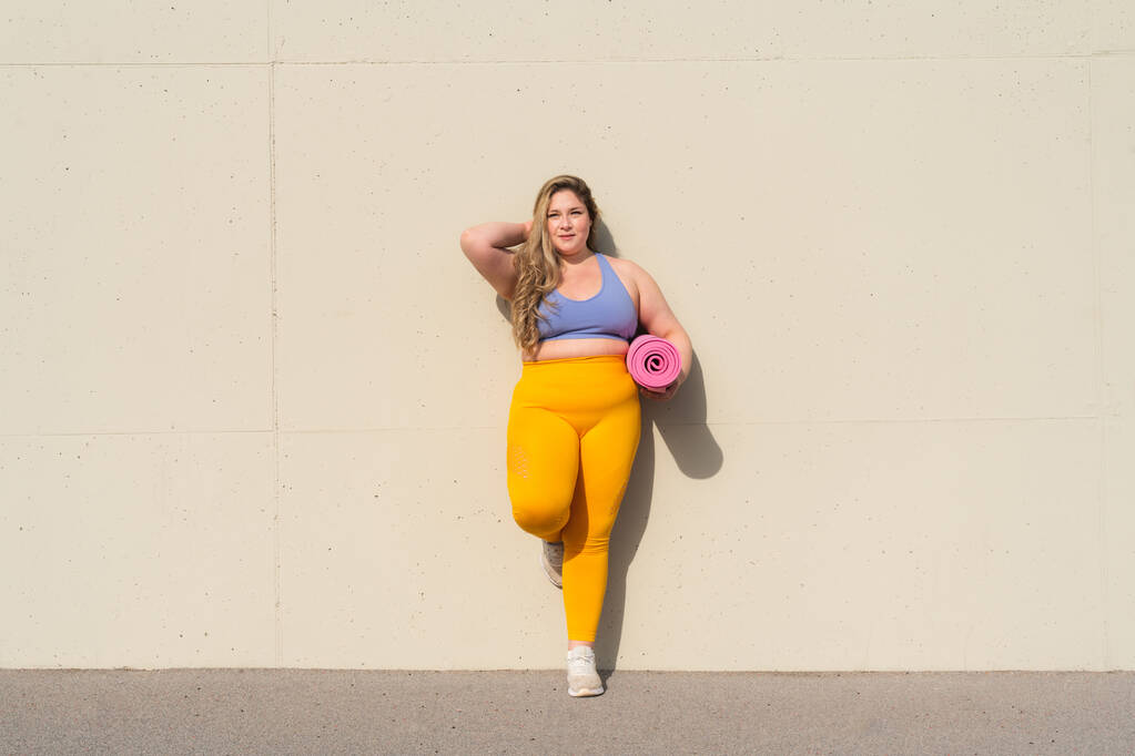 Beautiful and cheerful plus size young woman outdoors - Pretty overweight curvy female, concepts about femininity, women power, female emancipation, body positivity and body acceptance - Photo, Image