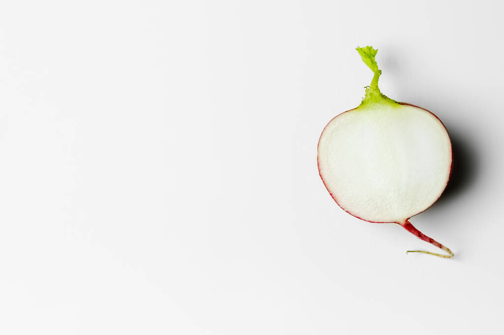 Top view of cut radish on white background with copy space - Foto, Imagem