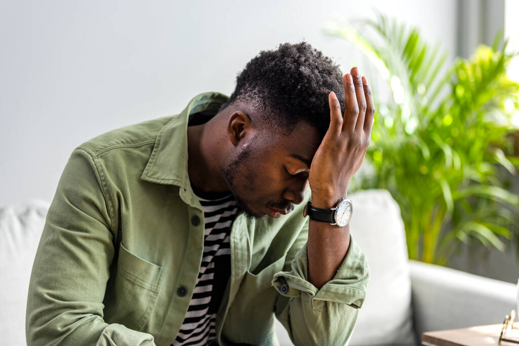 Young handsome man with hand on head for pain in head because stress. Suffering migraine. Headache. Young African man making a pain face.  - Foto, imagen