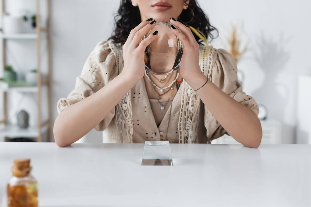 Cropped view of fortune teller holding orb at home  - Foto, imagen