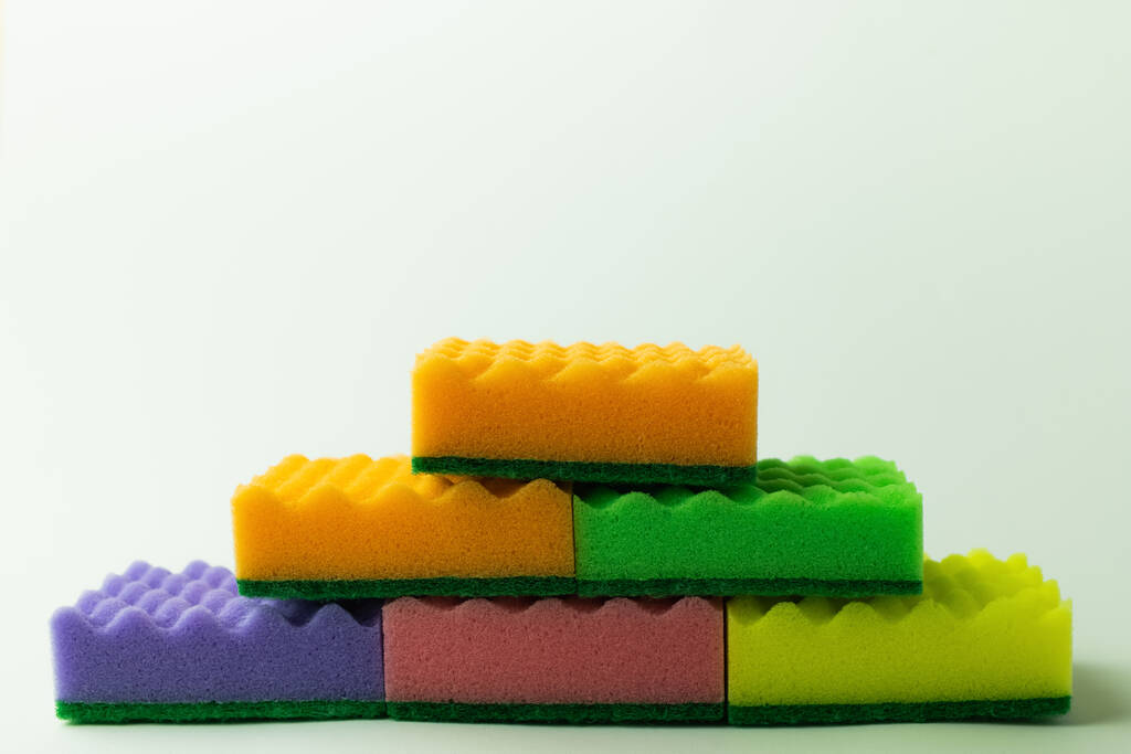 multicolored sponge scourers stacked on grey background - Foto, Imagen