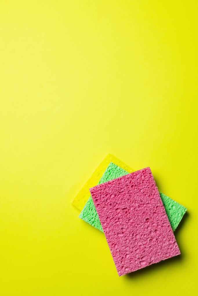 top view of colorful and textured sponge cloths on yellow background - Valokuva, kuva