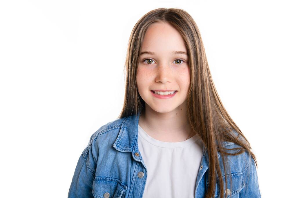 Young brunette pre teen girl on studio white - Foto, imagen
