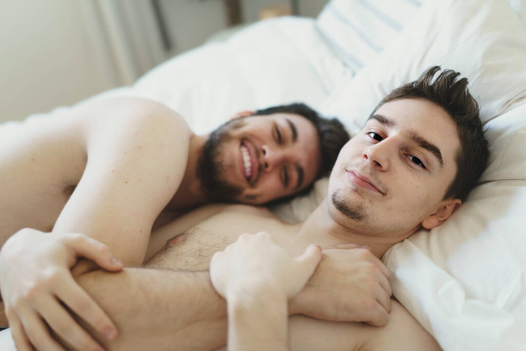 homosexual couple under a bed at home - 写真・画像