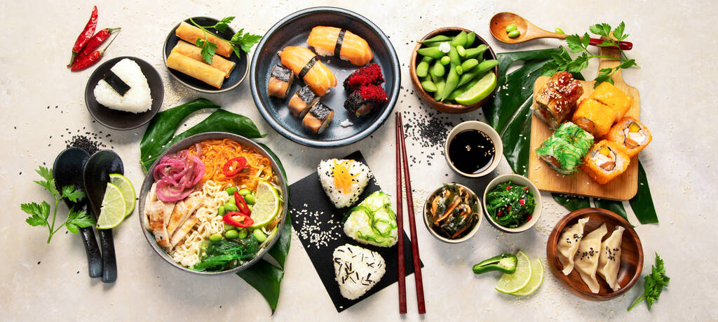 Japanese food assortment on light background. Traditional food concept. Dishes and appetizers of indeed cuisine. Top view, flat lay, panorama - Foto, immagini