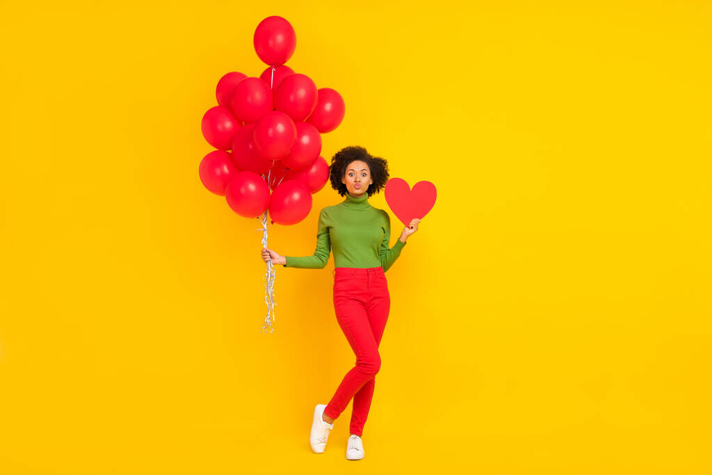 Full size photo of young lovely girl hold many balloons inflate card romantic isolated over yellow color background - Photo, Image