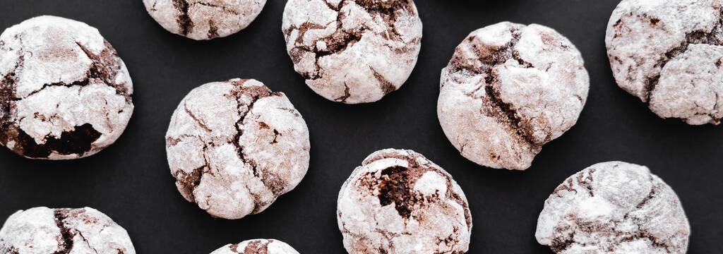 Top view of tasty biscuits with powdered sugar on black background, banner  - Fotografie, Obrázek