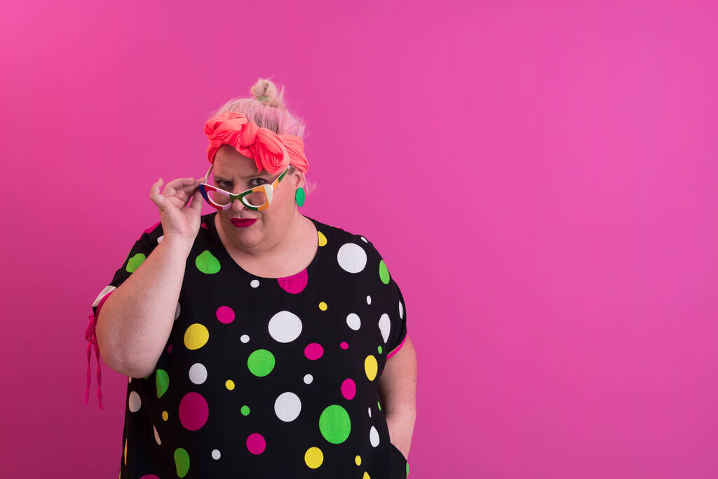 Happy Plus Size Woman Wearing Eyeglasses Smiling To Camera Standing Over Pink Background. Cheerful Millennial Female In Eyewear Posing In Studio. - Valokuva, kuva