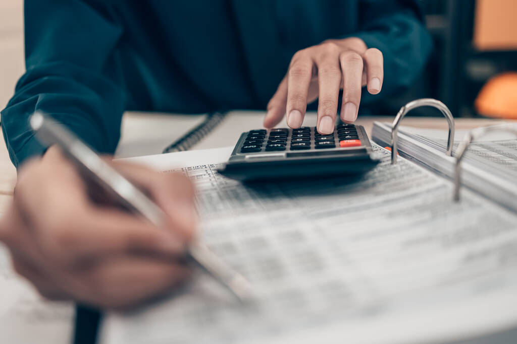 Investors working on desk office and using a calculator to calculate balance, projit, currency and cost. Accounting and  Financial concept. - Photo, Image