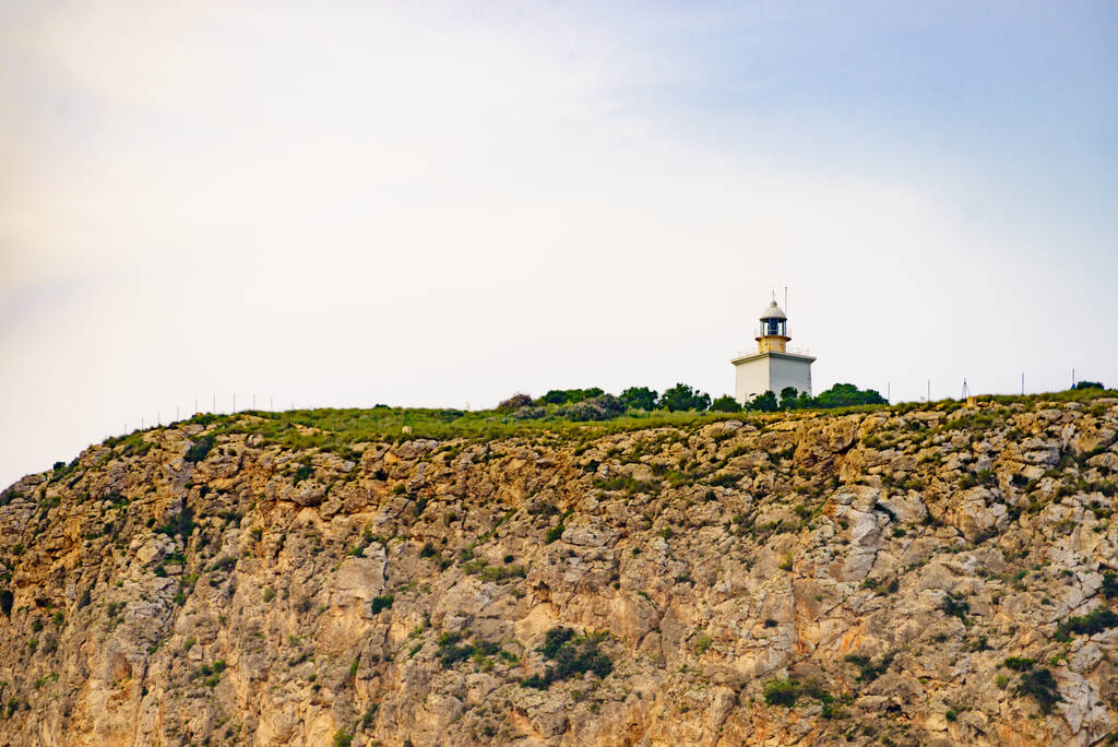 Spanish Costa Blanca coastline with lighthouse on cliff. Spain Alicante province, Santa Pola region. - Photo, image