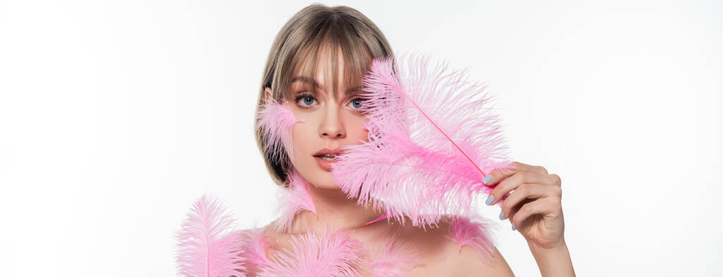 pretty woman with decorative beads on neck holding pink feathers isolated on white, banner - Foto, Imagem