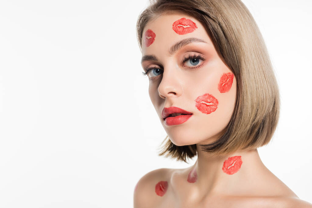 red kiss prints on cheeks and body of pretty young woman isolated on white - Fotoğraf, Görsel