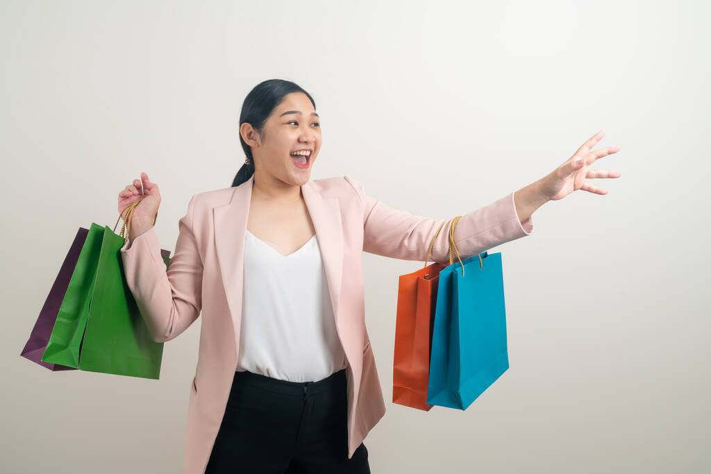 Asian woman holding shopping bag on hand with white background - Photo, Image