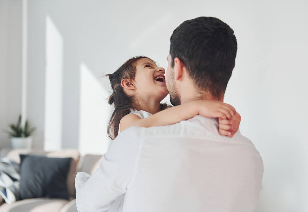 Happy father with his daughter embracing each other at home. - Fotografie, Obrázek