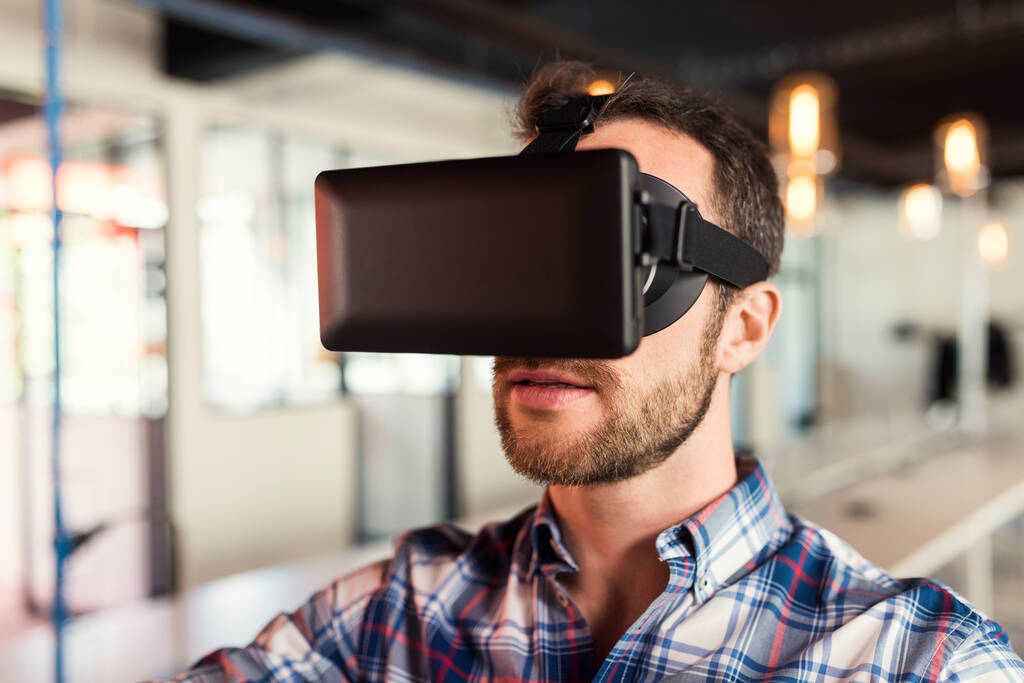 Man using virtual reality glasses in startup office. - Fotó, kép