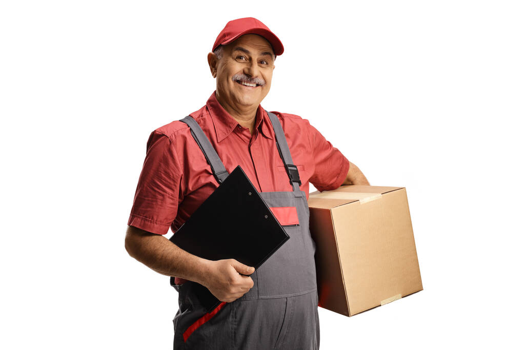 Delivery man holding a cardboard box and a clipboard isolated on white background  - Photo, image