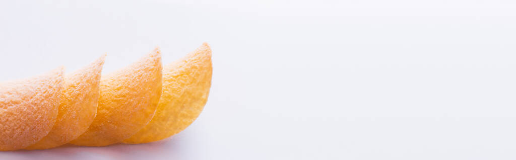 stacked and fried potato chips on white background, banner - Фото, изображение