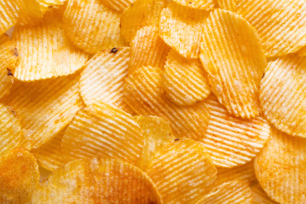 bunch of wavy and salty potato chips, top view - Φωτογραφία, εικόνα