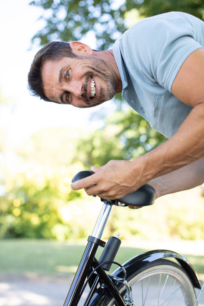 happy man adjusting fixed gear bike saddle - Photo, Image